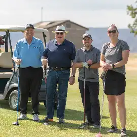Peoples at Golf Tournament smiling while holding golf clubs